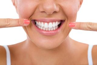 a woman points to her smile | candia nh preventive dentist